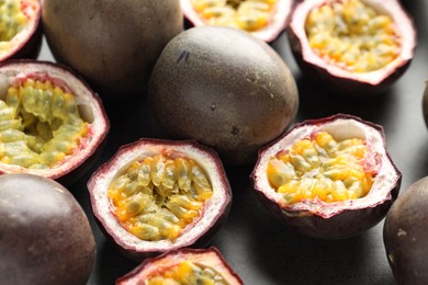 Photo of Fresh passion fruits on grey table, closeup