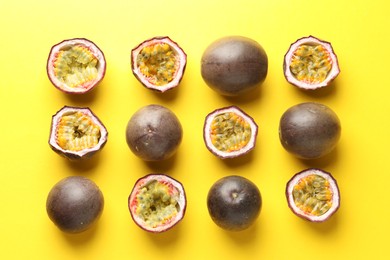 Photo of Fresh passion fruits on yellow background, flat lay