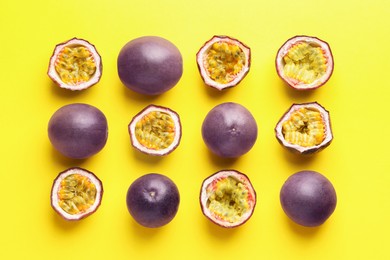 Photo of Fresh passion fruits on yellow background, flat lay