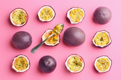 Photo of Fresh passion fruits and spoon on pink background, flat lay