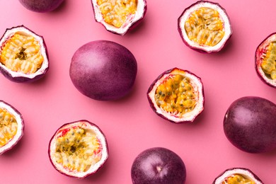 Photo of Fresh passion fruits on pink background, flat lay