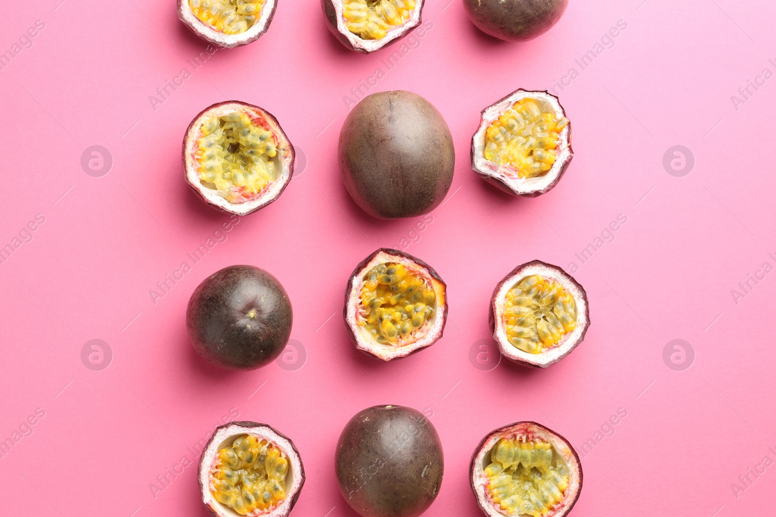 Photo of Fresh passion fruits on pink background, flat lay