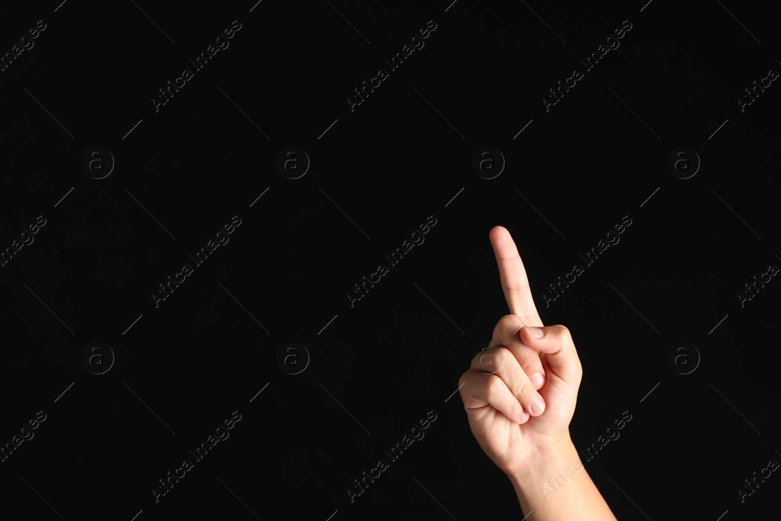 Photo of Man touching something on black background, closeup. Space for text