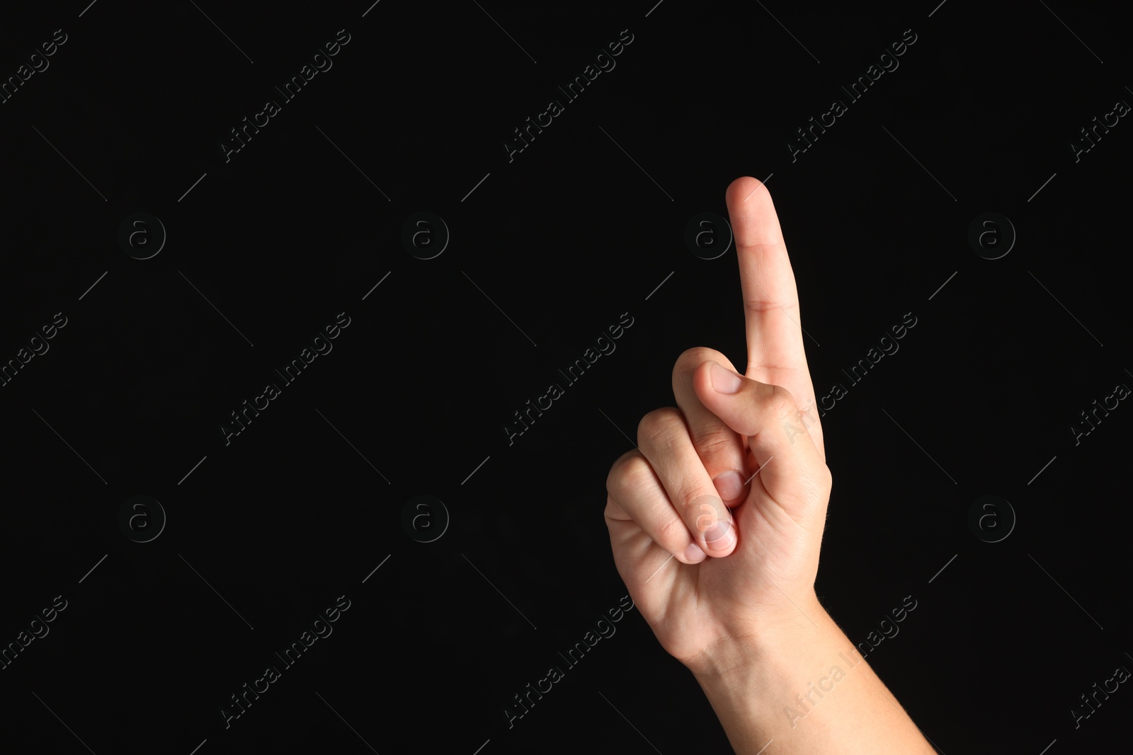 Photo of Man touching something on black background, closeup. Space for text