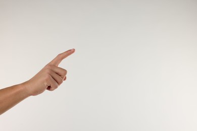 Photo of Man touching something on light grey background, closeup. Space for text