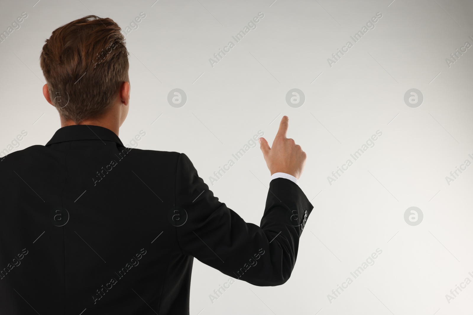 Photo of Man touching something on white background, back view. Space for text
