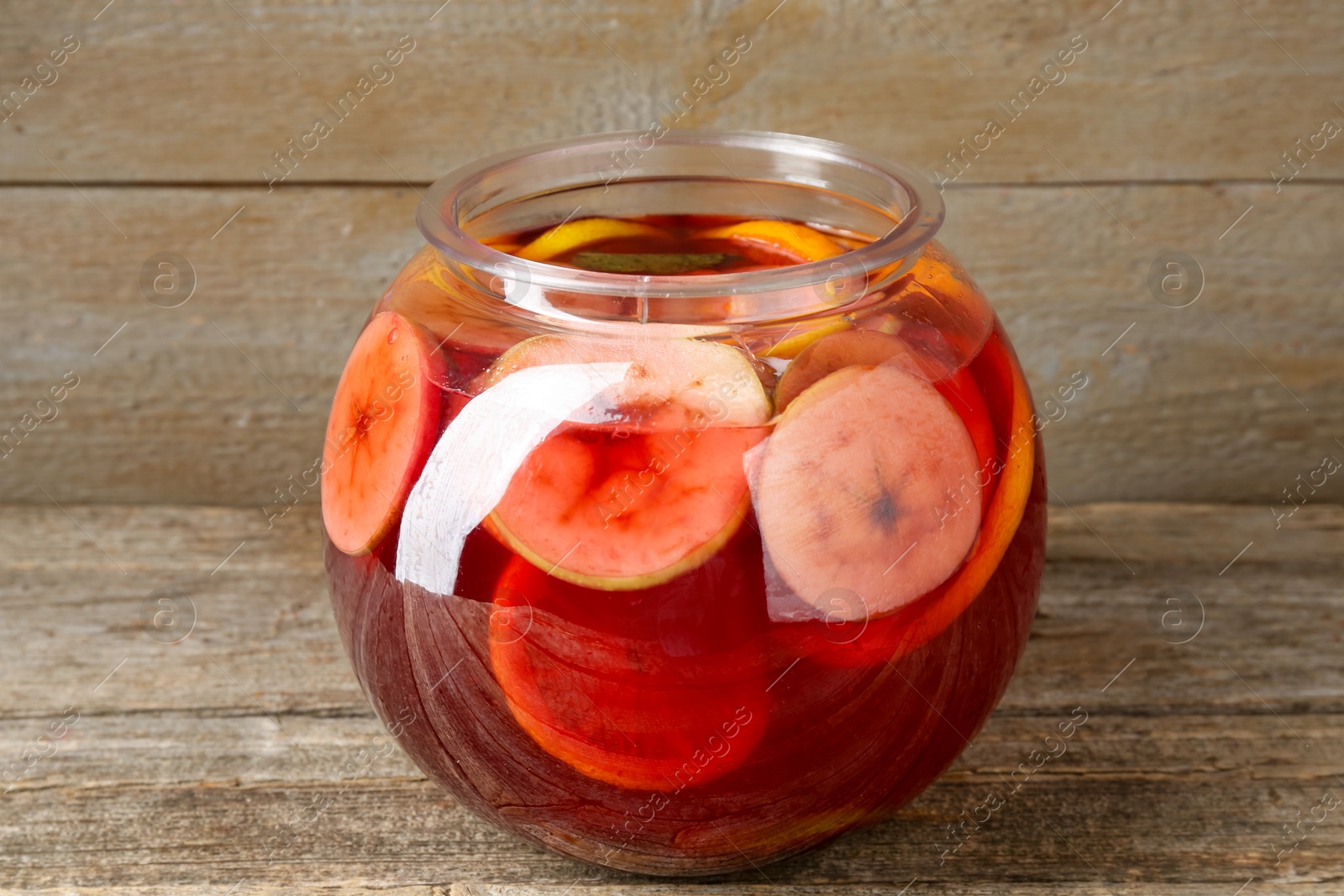 Photo of Tasty fruity punch on wooden table, closeup. Refreshing drink