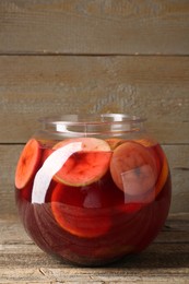 Photo of Tasty fruity punch on wooden table. Refreshing drink