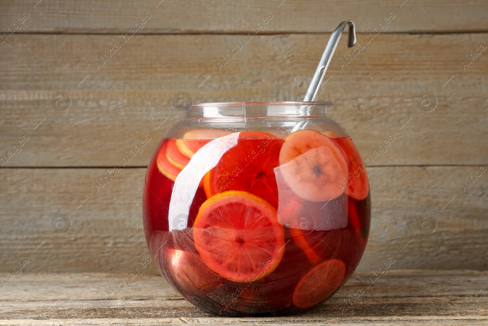 Tasty fruity punch on wooden table. Refreshing drink Photo of Tasty fruity punch on wooden table. Refreshing drink
