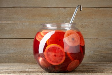 Photo of Tasty fruity punch on wooden table. Refreshing drink
