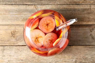 Photo of Tasty fruity punch on wooden table, top view. Refreshing drink