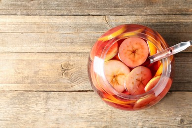 Photo of Tasty fruity punch on wooden table, top view with space for text. Refreshing drink