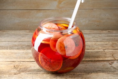 Photo of Tasty fruity punch on wooden table. Refreshing drink