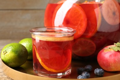 Photo of Tasty punch and fruits on wooden table, closeup. Refreshing drink