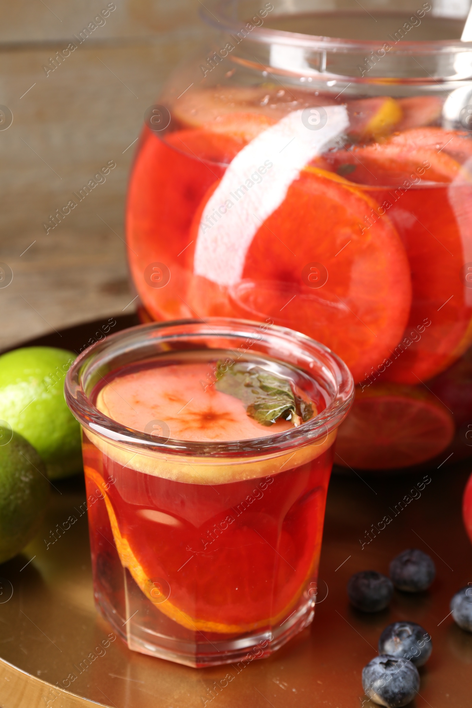 Photo of Tasty punch and fruits on wooden table, closeup. Refreshing drink