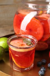 Photo of Tasty punch and fruits on wooden table, closeup. Refreshing drink