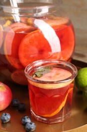 Photo of Tasty punch and fruits on wooden table, closeup. Refreshing drink