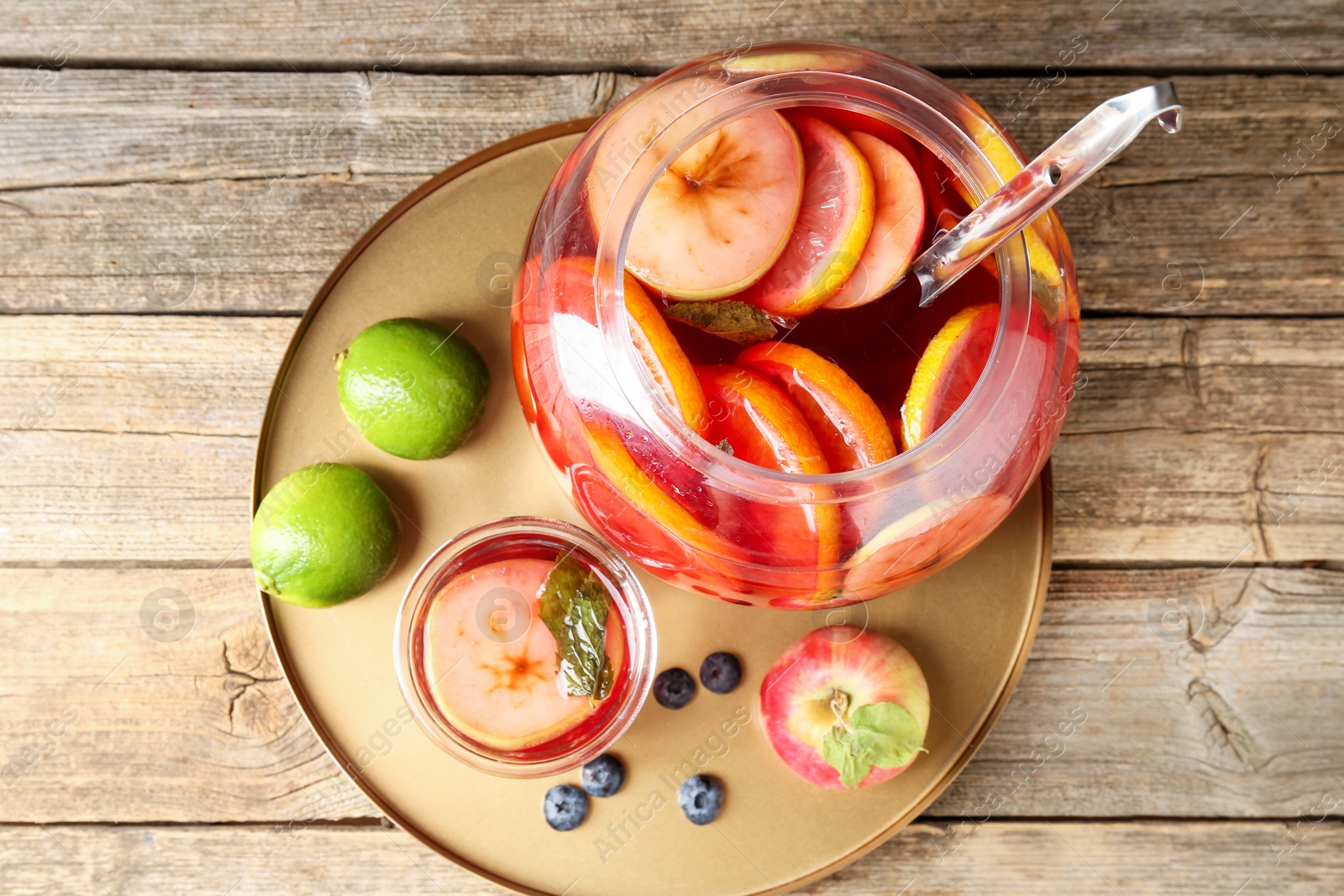 Photo of Tasty punch and fruits on wooden table, top view. Refreshing drink