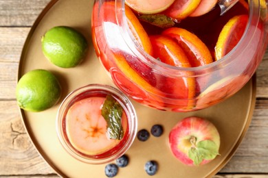 Photo of Tasty punch and fruits on wooden table, top view. Refreshing drink