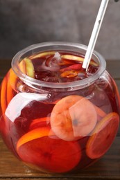 Photo of Tasty fruity punch on wooden table. Refreshing drink