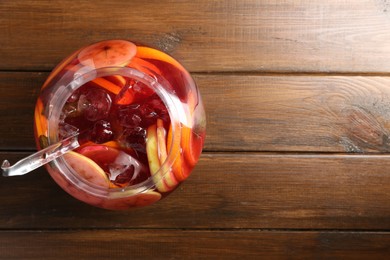 Photo of Tasty fruity punch on wooden table, top view with space for text. Refreshing drink
