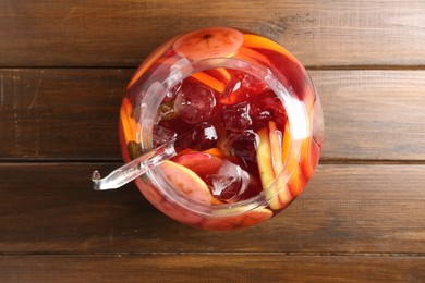 Photo of Tasty fruity punch on wooden table, top view. Refreshing drink