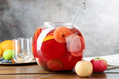 Photo of Tasty punch and fruits on wooden table. Refreshing drink