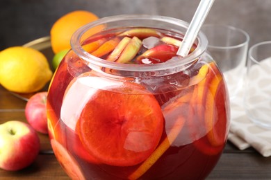 Photo of Tasty punch and fruits on wooden table, closeup. Refreshing drink