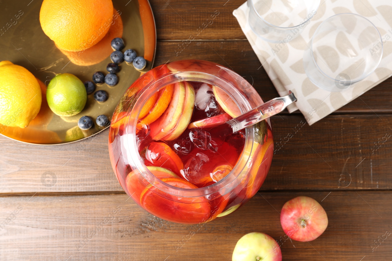 Photo of Tasty punch and fruits on wooden table, flat lay. Refreshing drink