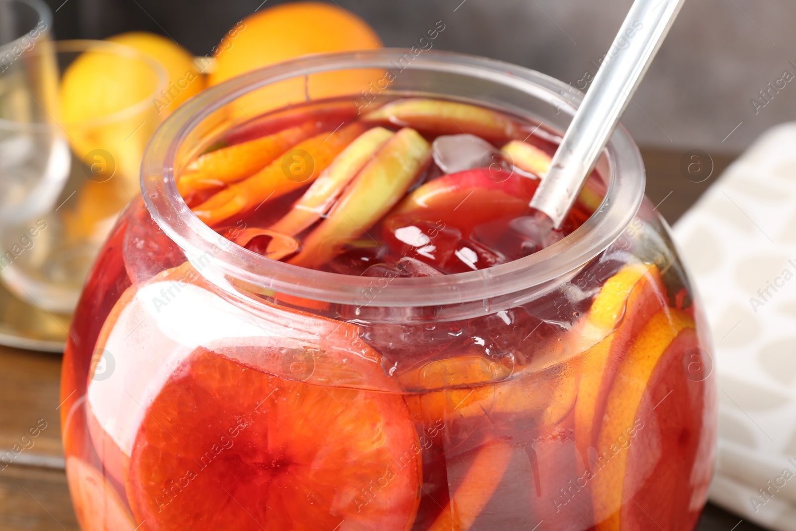 Photo of Tasty fruity punch on wooden table, closeup. Refreshing drink