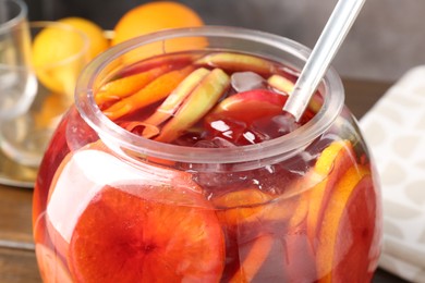 Photo of Tasty fruity punch on wooden table, closeup. Refreshing drink