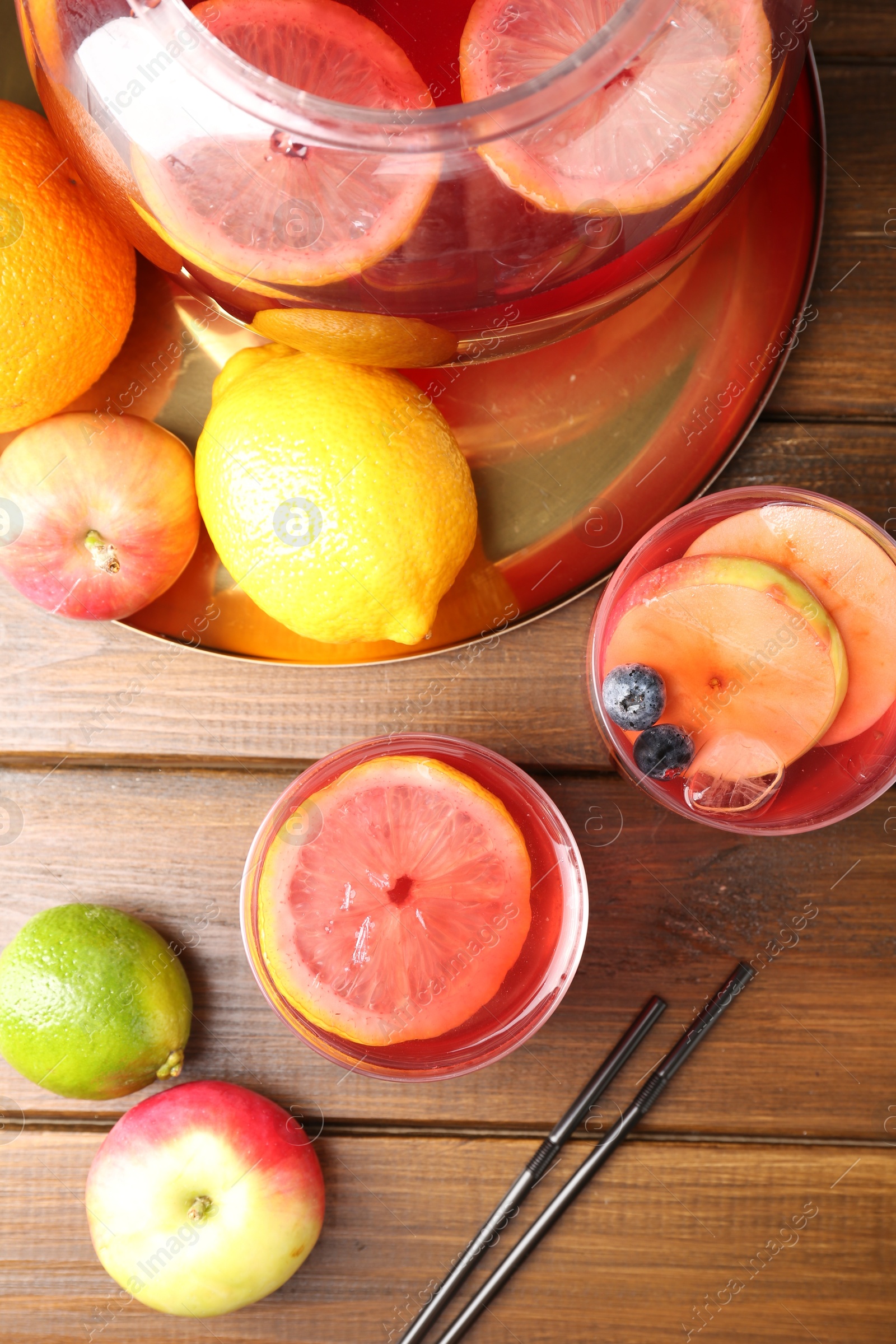 Tasty punch and fruits on wooden table, flat lay. Refreshing drink Photo of Tasty punch and fruits on wooden table, flat lay. Refreshing drink