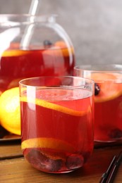 Photo of Tasty punch and fruits on wooden table, closeup. Refreshing drink