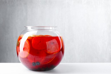 Photo of Tasty fruity punch on white table, space for text. Refreshing drink