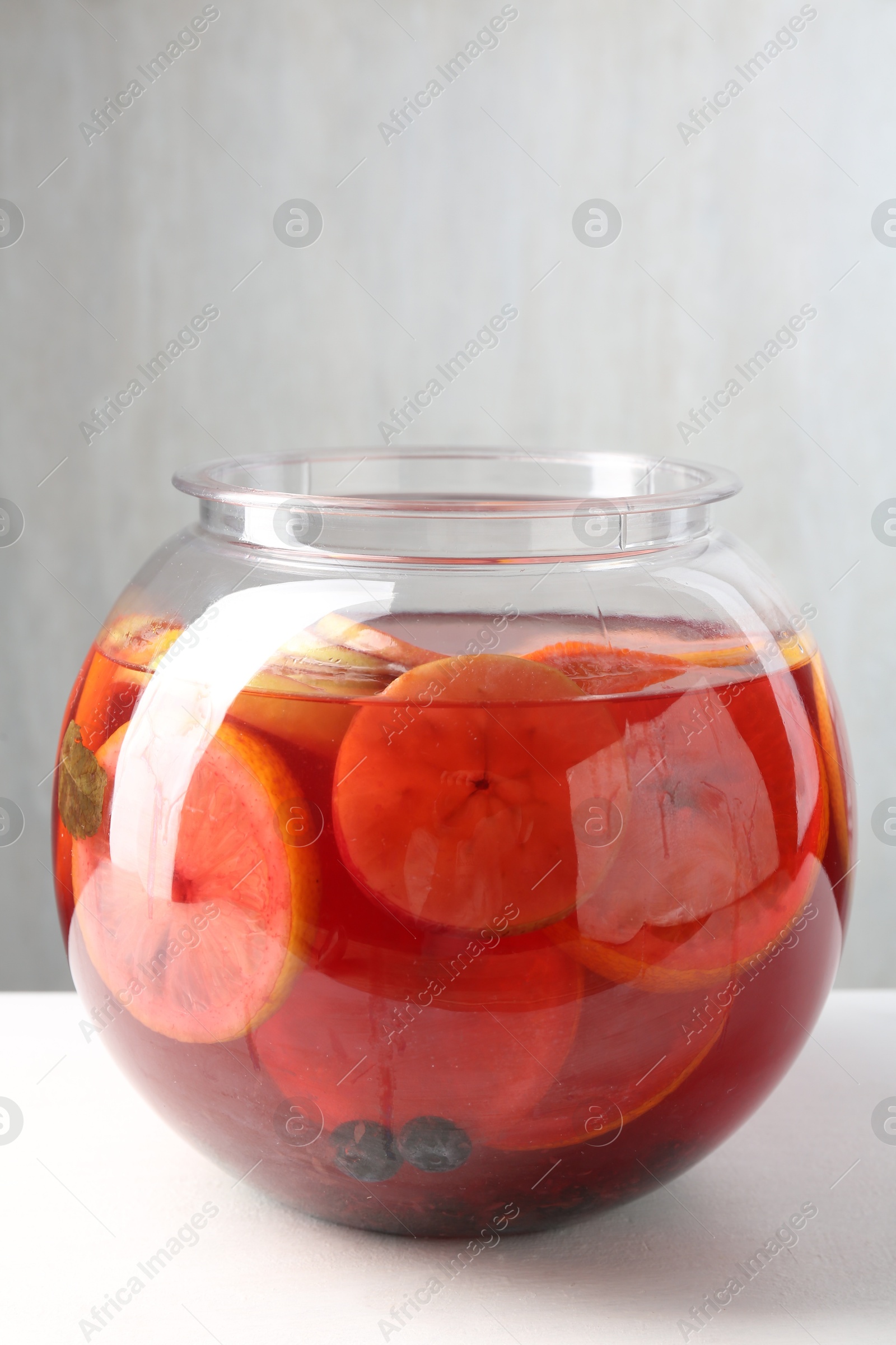 Tasty fruity punch on white table. Refreshing drink Photo of Tasty fruity punch on white table. Refreshing drink