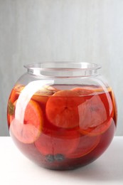 Photo of Tasty fruity punch on white table. Refreshing drink