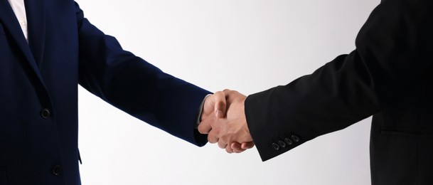 Photo of Business partners shaking hands on white background, closeup