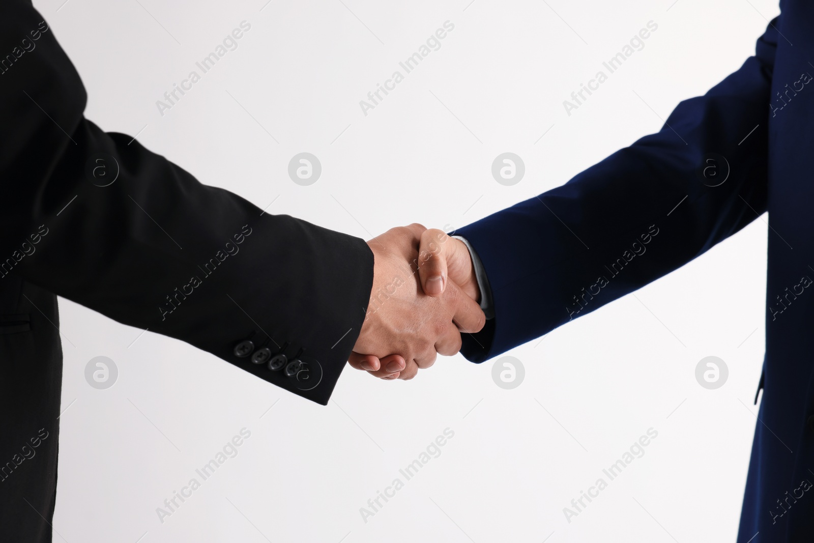 Business partners shaking hands on white background, closeup Photo of Business partners shaking hands on white background, closeup