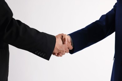 Photo of Business partners shaking hands on white background, closeup
