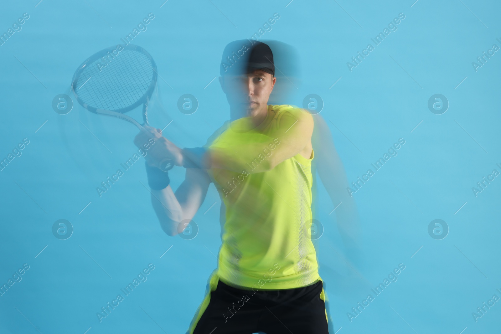 Man with racket playing tennis on light blue background, motion blur effect Photo of Man with racket playing tennis on light blue background, motion blur effect