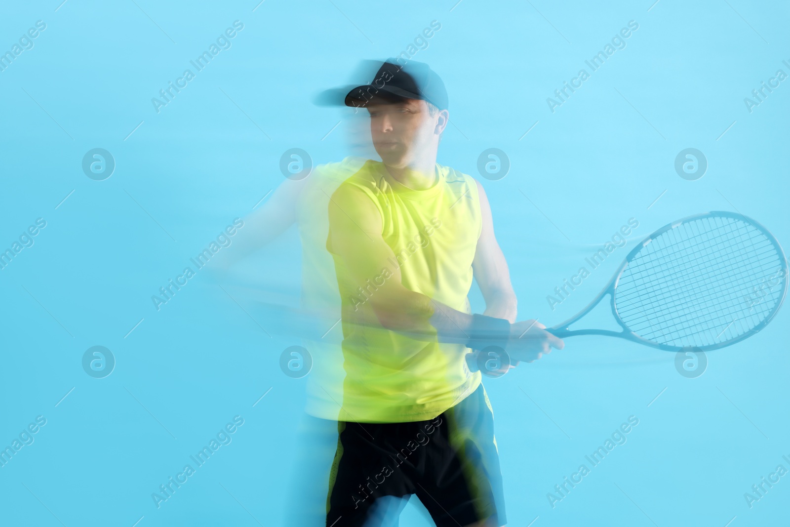 Man with racket playing tennis on light blue background, motion blur effect Photo of Man with racket playing tennis on light blue background, motion blur effect
