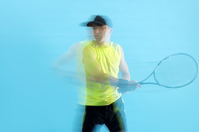Photo of Man with racket playing tennis on light blue background, motion blur effect