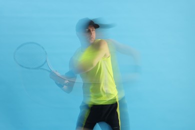 Photo of Man with racket playing tennis on light blue background, motion blur effect
