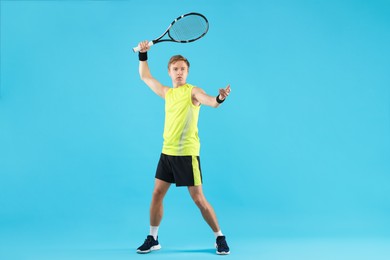 Photo of Man with tennis racket on light blue background