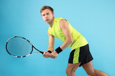 Photo of Man with tennis racket on light blue background