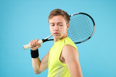 Photo of Man with tennis racket on light blue background