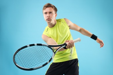 Photo of Man with tennis racket on light blue background