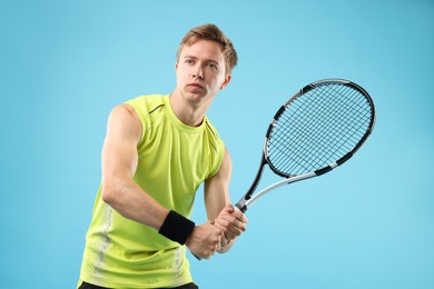 Photo of Man with tennis racket on light blue background