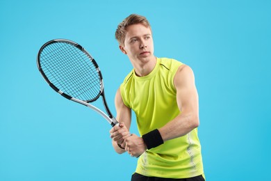 Photo of Man with tennis racket on light blue background