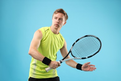 Photo of Man with tennis racket on light blue background